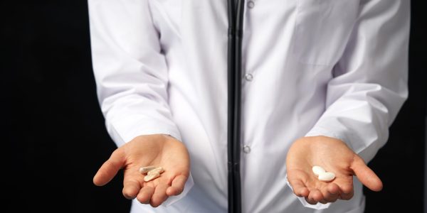 Cropped,View,Of,Female,Doctor,Holding,In,Hands,Pills,To